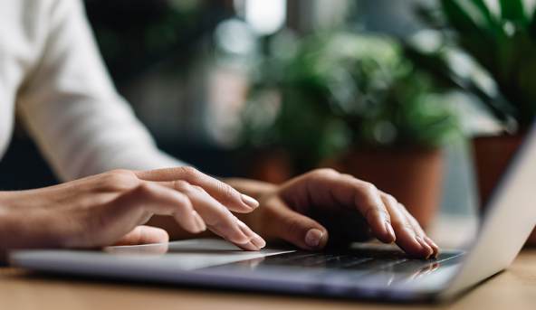 hands typing on laptop