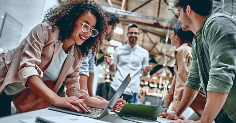Group of men and women employees working together at a company